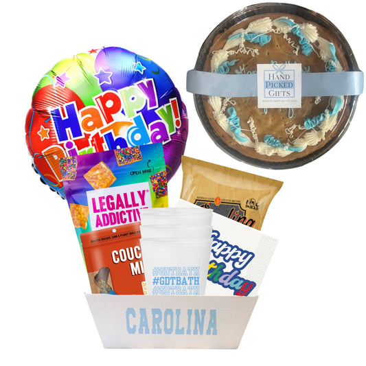 gift basket containing cookie cake, NC made Legally Addictive cookies, UNC stickers, UNC gummy candies, Carolina BBQ chips, and a UNC insulated cup to be delivered to UNC students at Chapel Hill.