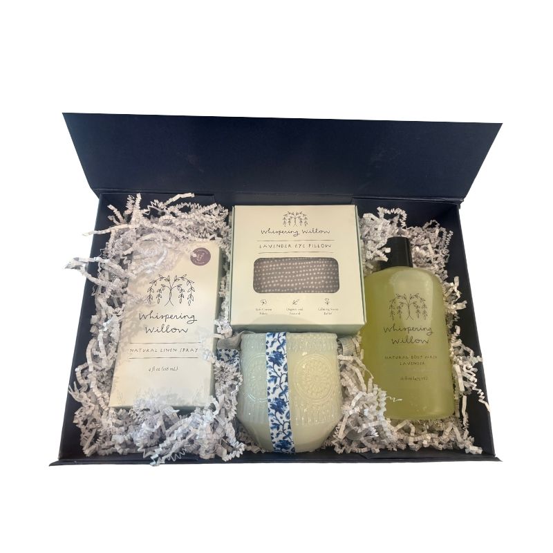 Alternate angle of open luxury gift box displaying lavender self-care items, showcasing elegant presentation of candle, body wash, linen spray, and eye pillow