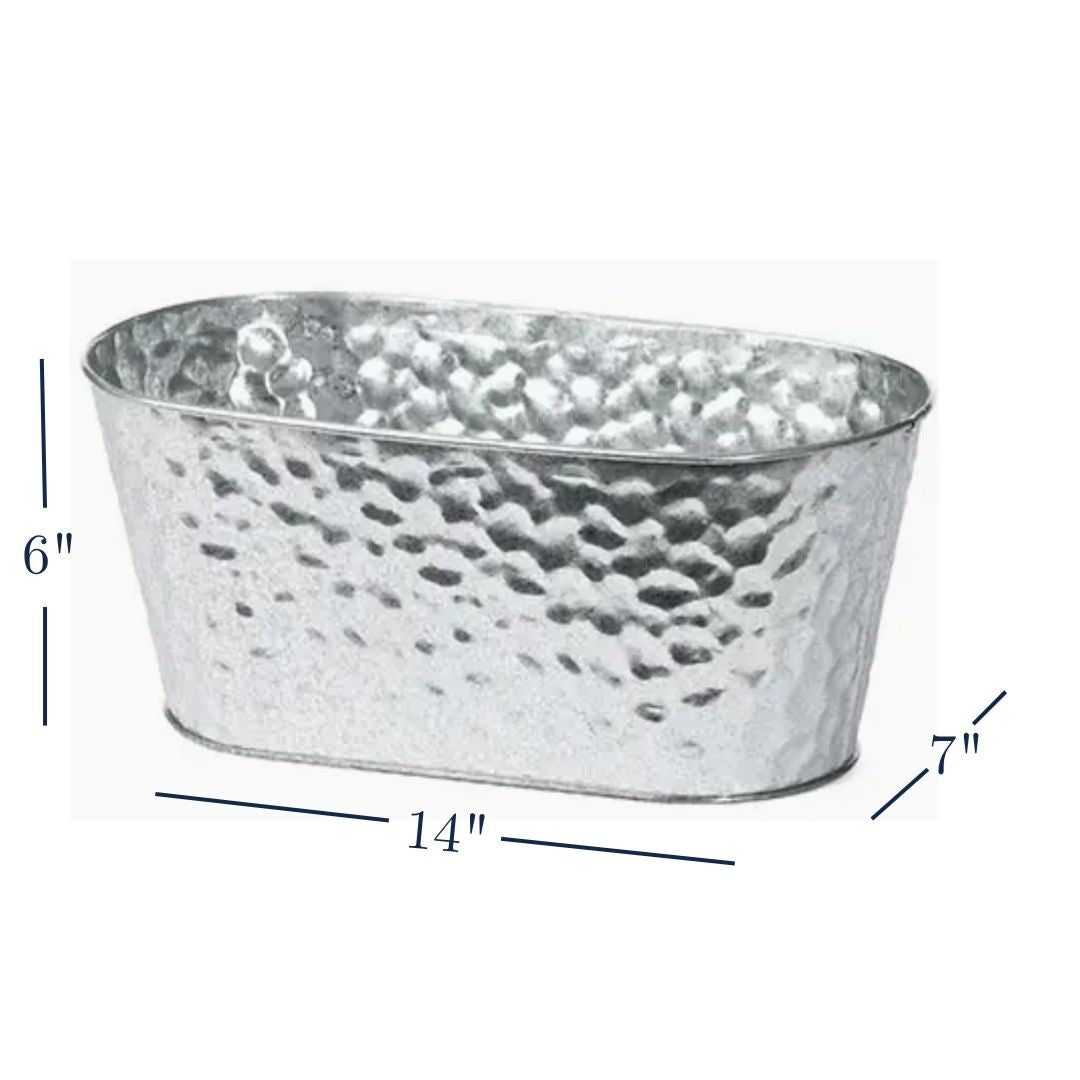 Beautiful, hammered metal planter that is used as base of luxury gift basket featuring North Carolina gourmet gifts