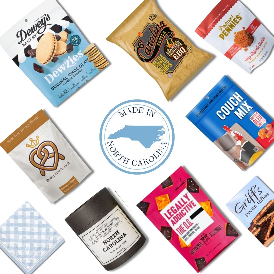 flat lay display of all NC products that are included in the NC Flavors gift basket. Includes North Carolina candle and c=gourmet treats that are locally made