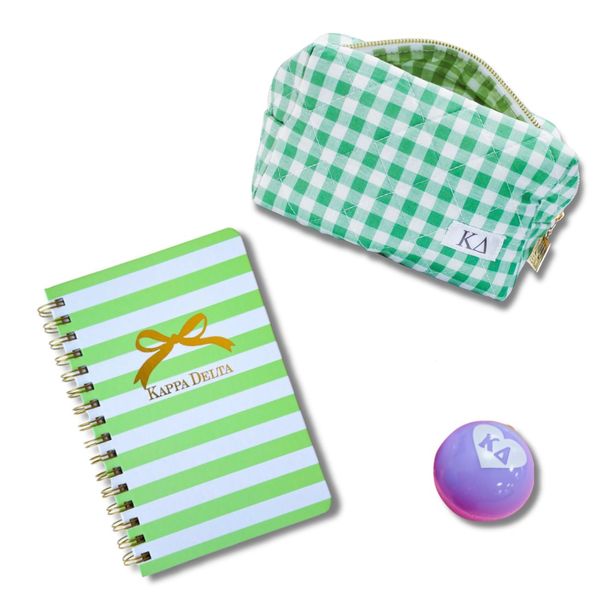 Green and white striped notebook, green checkered pouch, and purple ball with Kappa Delta logo on a white background, sorority sister gift for Bid Day