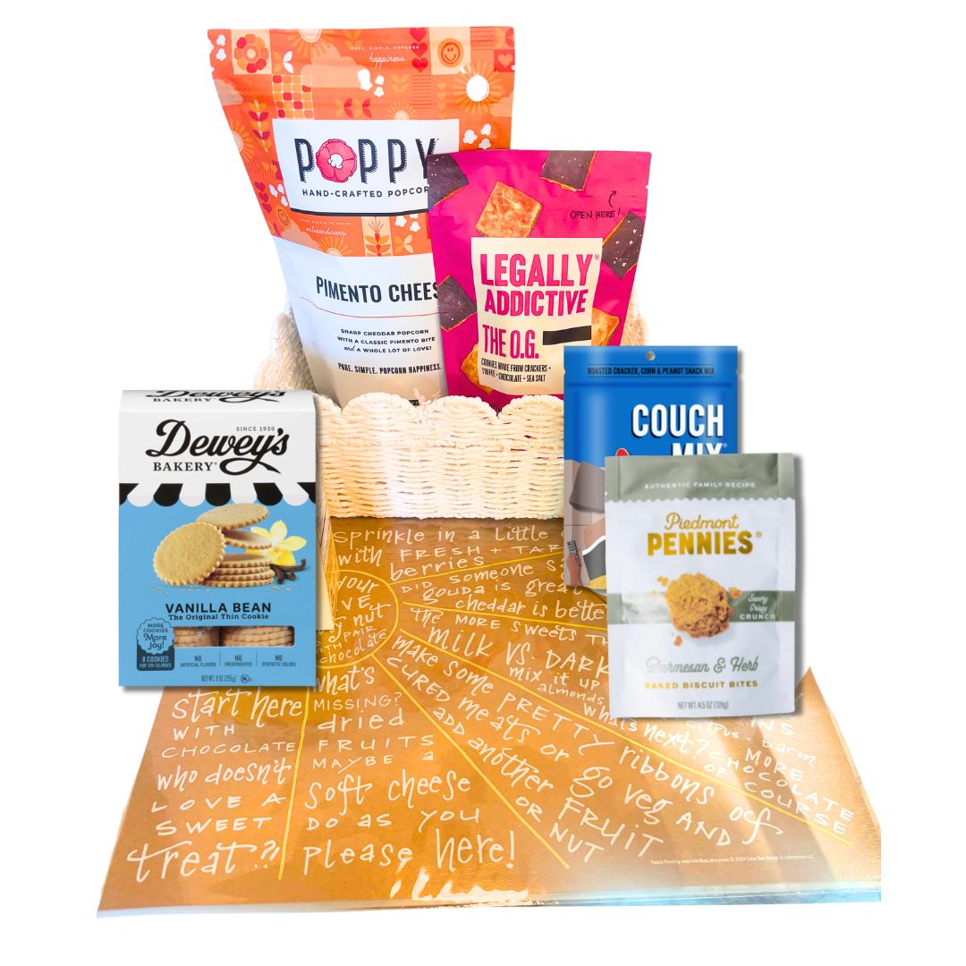 Lifestyle image featuring Sunburst Charcuterie Cheat Sheet with NC-made snacks like popcorn, cookies, and cheese wafers arranged on a counter.