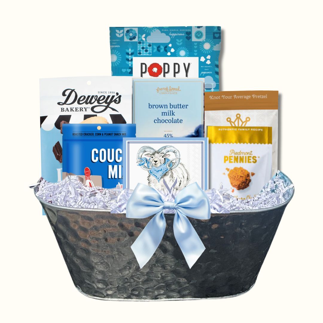 Gift Basket full of locally made in North Carolina products including Dewey's Vanilla Cookies, Queen City Crunch pretzels, Couch Mix, French Broad Chocolate, Ram beverage napkins, Piedmont Pennies