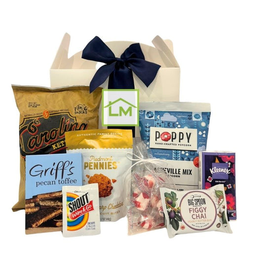 Custom North Carolina event welcome box featuring local snacks and essentials, shown with a sample corporate logo on the front label