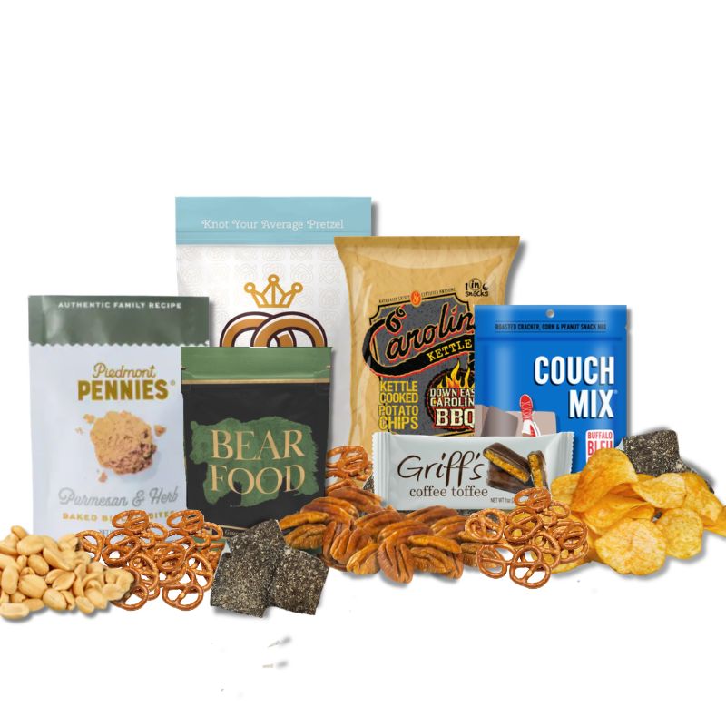 Carolina Sampler gift items displayed on a tabletop with loose BBQ chips, toffee, pecans, and pretzels