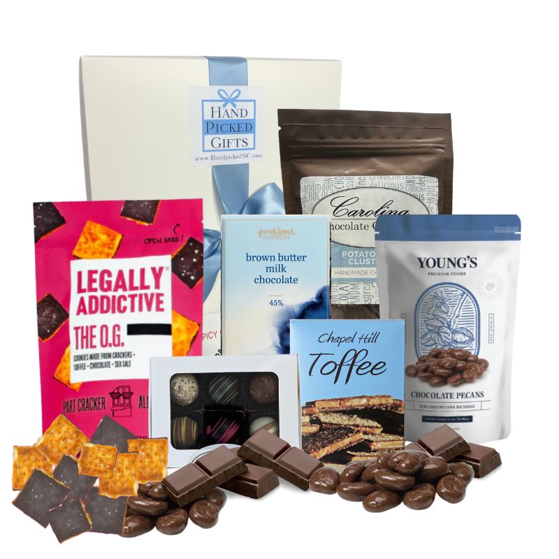 Chocolate Lover’s Delight gift box displayed on a tabletop with all contents arranged around it, including chocolate cookies, toffee, chocolate bars, truffles, chocolate potato chip clusters, and chocolate-covered pecans made in North and South Carolina.