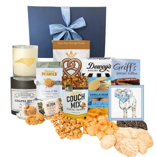 Chapel Hill Signature Gift Set featuring premium UNC gifts and locally made treats like chocolates, pretzels, and cheese wafers, displayed in front of the navy gift box
