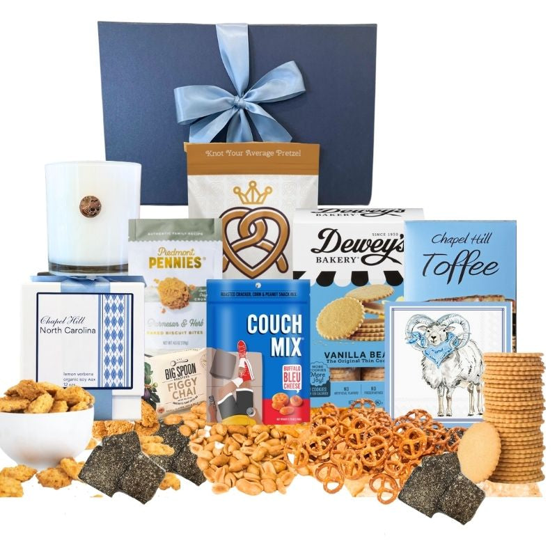 Chapel Hill Signature Gift Set featuring premium UNC gifts and locally made treats like chocolates, pretzels, and cheese wafers, displayed in front of the navy gift box