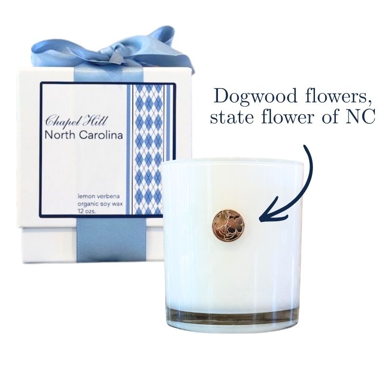 Luxury candle with UNC Chapel Hill argyle and gold emblem of dogwood flowers, state flower of NC