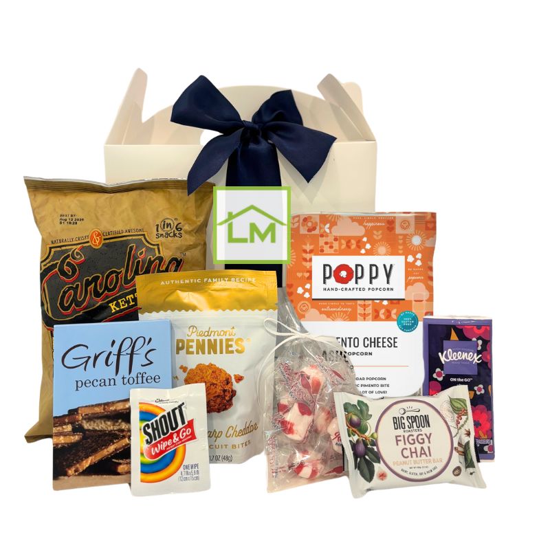 Custom North Carolina event welcome box featuring local snacks and essentials, shown with a sample corporate logo on the front label