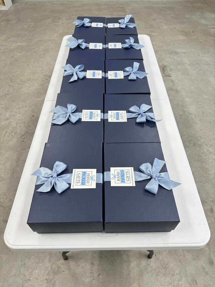 Navy corporate gift boxes with blue ribbon bows staged for bulk North Carolina delivery