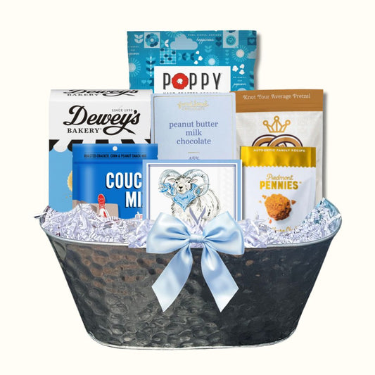 Gift Basket full of locally made in North Carolina products including Dewey's Vanilla Cookies, Queen City Crunch pretzels, Couch Mix, French Broad Chocolate, Ram beverage napkins, Piedmont Pennies