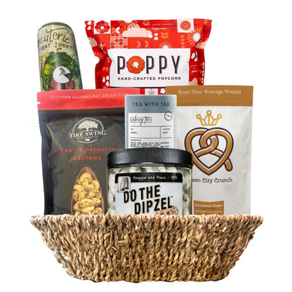 Basket filled with various snacks and treats on a white background