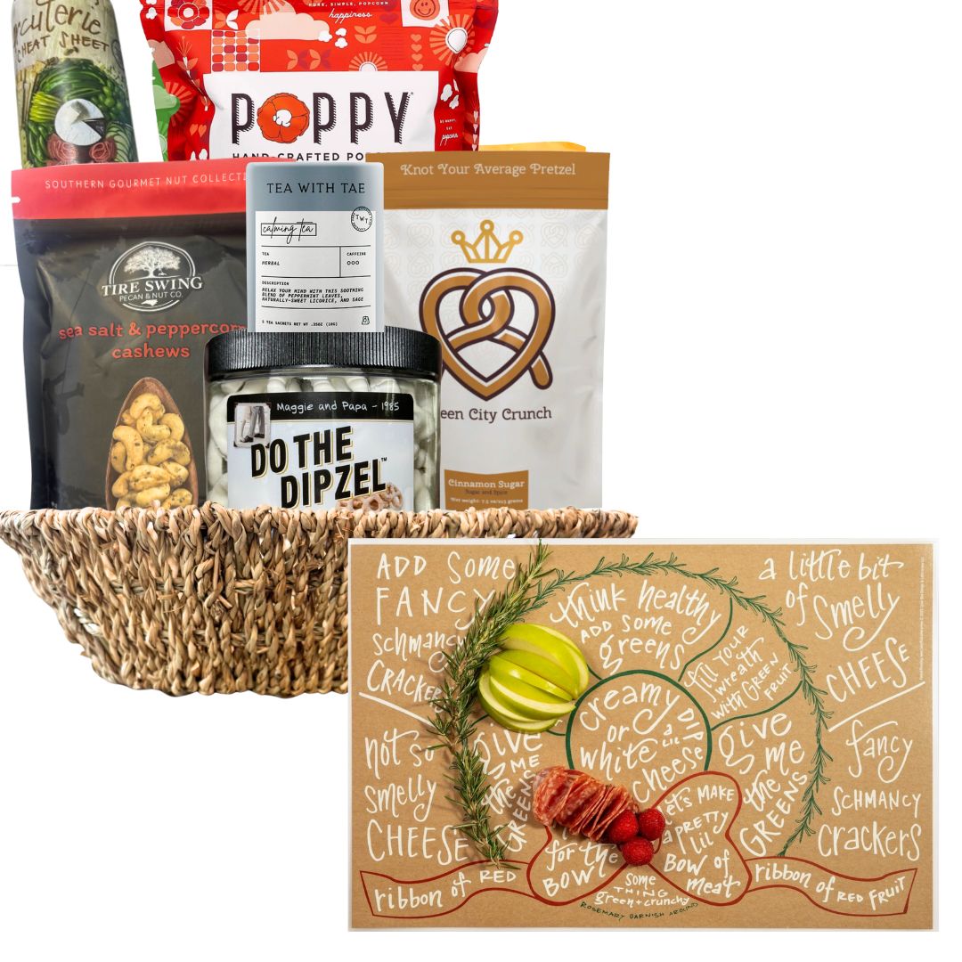 Gourmet gift basket with various items including popcorn, chocolate, and nuts on a white background.