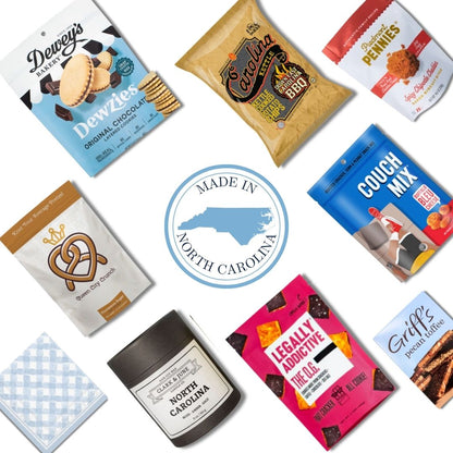 flat lay display of all NC products that are included in the NC Flavors gift basket. Includes North Carolina candle and c=gourmet treats that are locally made