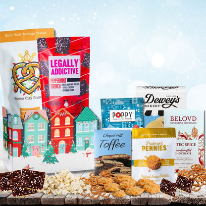 Elegant gift basket featuring locally made gourmet items from North Carolina wrapped in a festive winter themed holiday Christmas box with bright colors and winter scenes.