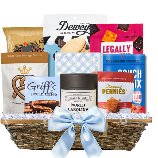 Gourmet Gift basket featuring a candle with the gold North Carolina silhouette and a variety of other made in North Carolina Gourmet foods.