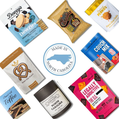 flat lay display of all NC products that are included in the NC Flavors gift basket. Includes North Carolina candle and c=gourmet treats that are locally made