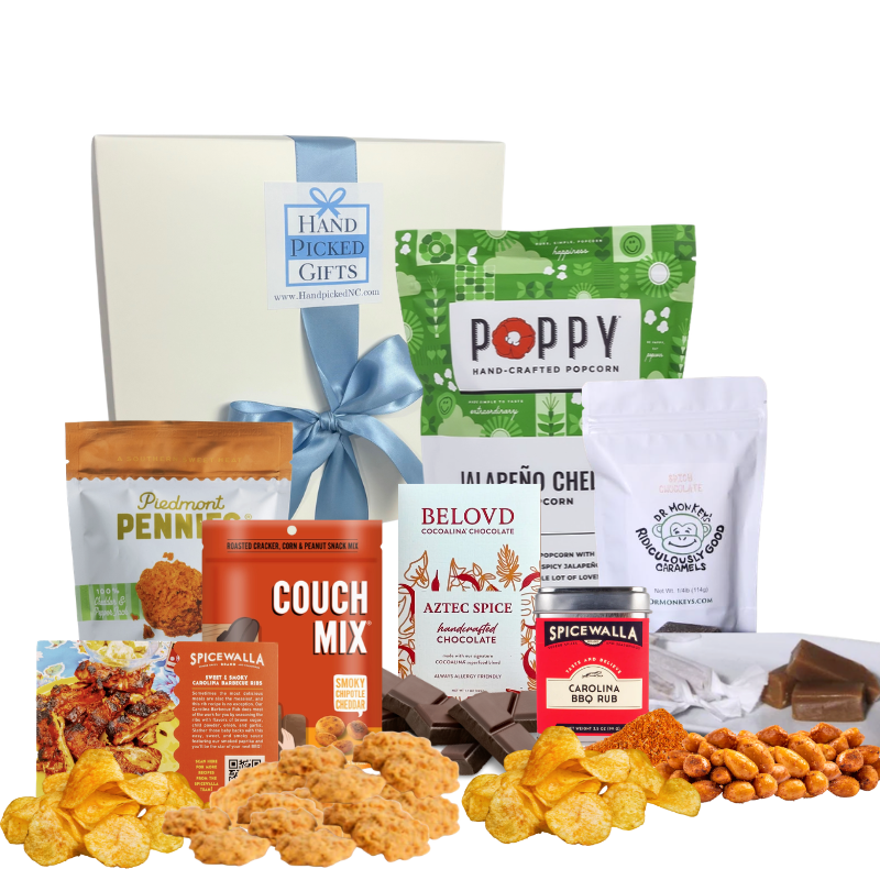 Assorted spicy gourmet foods that are from North Carolina arranged in front of a white Handpicked Gifts gift box