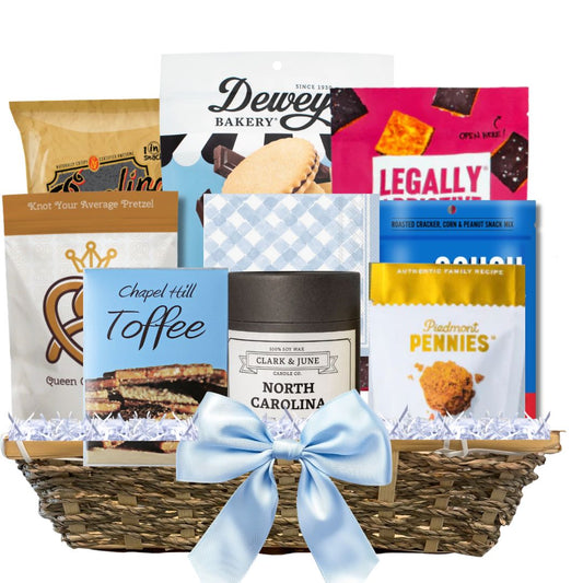 Gourmet Gift basket featuring a candle with the gold North Carolina silhouette and a variety of other made in North Carolina Gourmet foods.