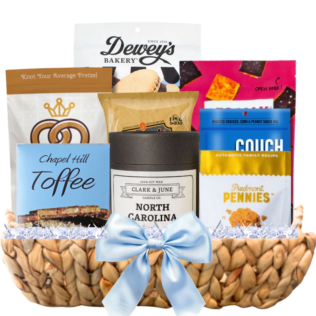 Gourmet Gift basket featuring a candle with the gold North Carolina silhouette and a variety of other made in North Carolina Gourmet foods.