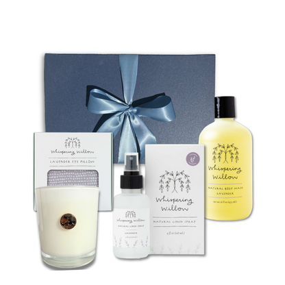 Luxury lavender self-care gift box standing upright with body wash, linen spray, eye pillow, and soy candle arranged in front, showcasing all included items