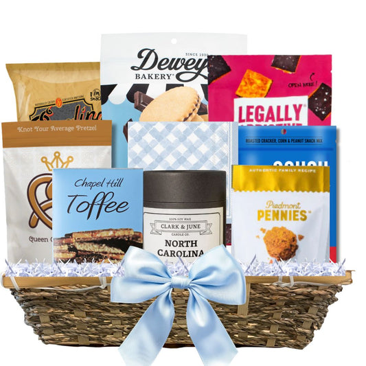Gourmet Gift basket featuring a candle with the gold North Carolina silhouette and a variety of other made in North Carolina Gourmet foods.