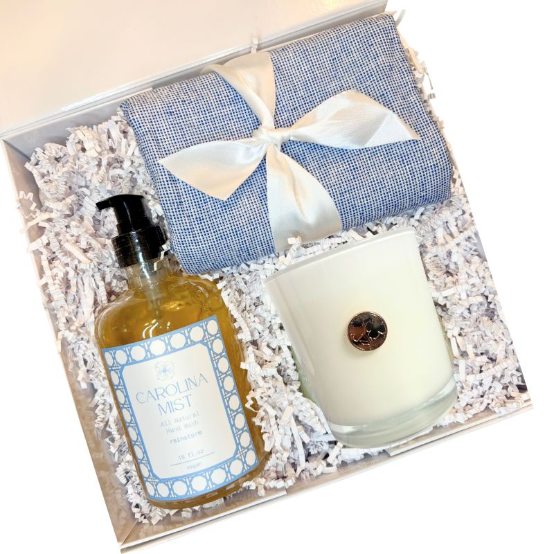 Luxury Gift set with bottle labeled 'Carolina Mist' and a candle in a decorative box.