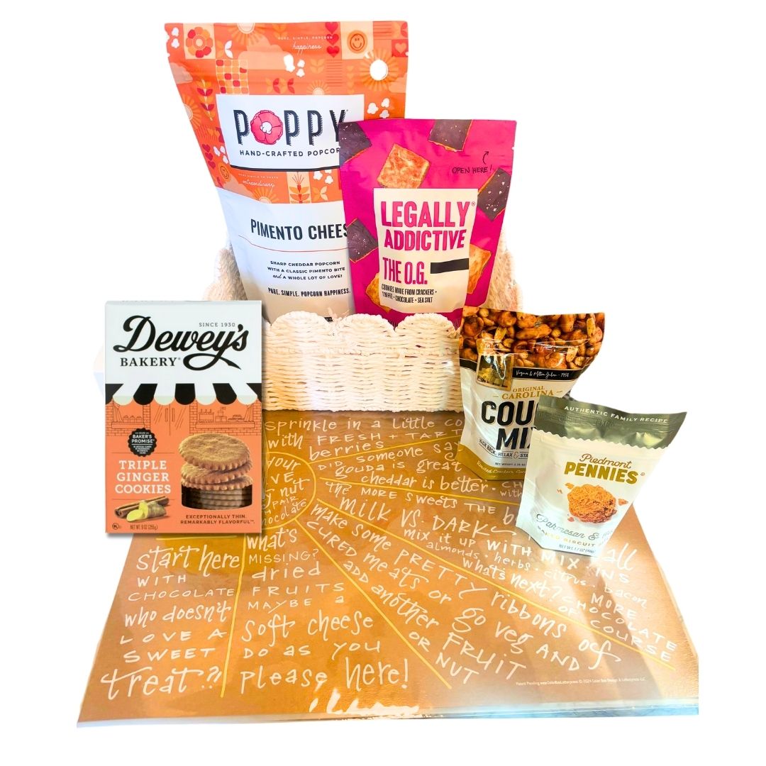 Lifestyle image featuring Sunburst Charcuterie Cheat Sheet with NC-made snacks like popcorn, cookies, and cheese wafers arranged on a counter.