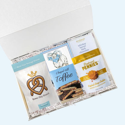 UNC snack gift box with North Carolina specialty treats and Tar Heels napkins in luxury gift box
