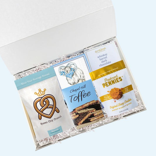 UNC snack gift box with North Carolina specialty treats and Tar Heels napkins in luxury gift box