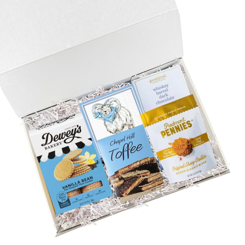 UNC snack gift box with North Carolina specialty treats and Tar Heels napkins in luxury gift box