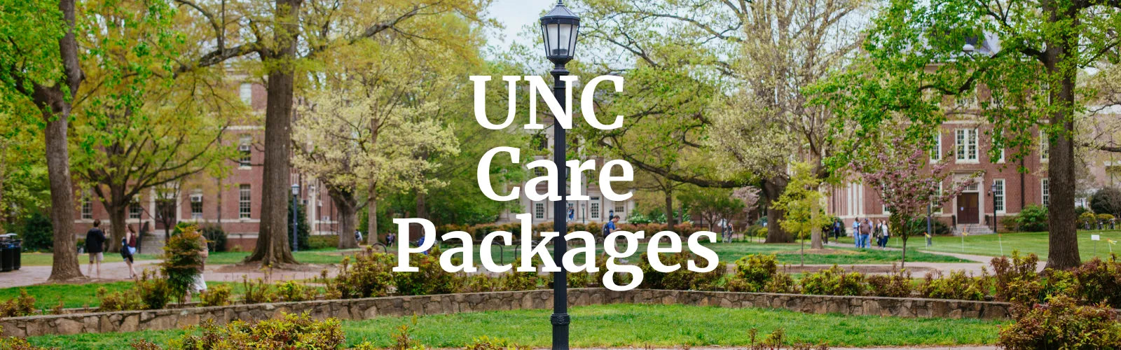 University campus with trees and a lamp post, featuring 'UNC Care Packages' text.