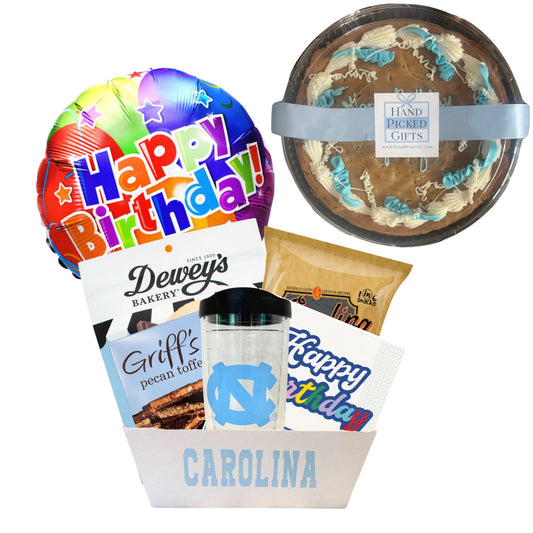 gift basket containing cookie cake, NC made Legally Addictive cookies, UNC stickers, UNC gummy candies, Carolina BBQ chips, and a UNC insulated cup to be delivered to UNC students at Chapel Hill.
