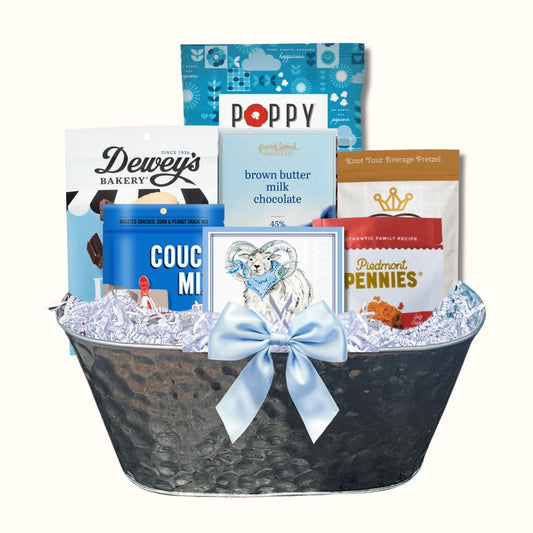 Gift Basket full of locally made in North Carolina products including Dewey's Vanilla Cookies, Queen City Crunch pretzels, Couch Mix, French Broad Chocolate, Ram beverage napkins, Piedmont Pennies