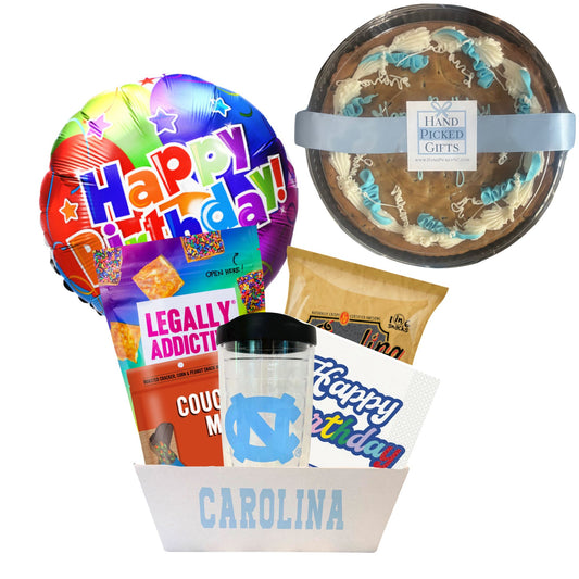 gift basket containing cookie cake, NC made Legally Addictive cookies, UNC stickers, UNC gummy candies, Carolina BBQ chips, and a UNC insulated cup to be delivered to UNC students at Chapel Hill.