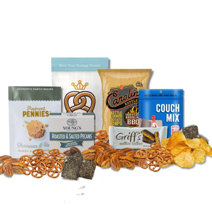 Carolina Sampler gift items displayed on a tabletop with loose BBQ chips, toffee, pecans, and pretzels