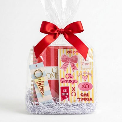 gift bag with chi omega key chain, notebook and sticker sheet for bid day, big sister little sister and initiation celebrations