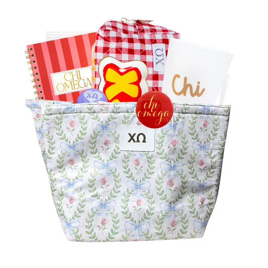 Tote bag with 'chi omega' letters, notebook, and other items on a white background, perfect for bid day, initiation, or big sis/lil sis
