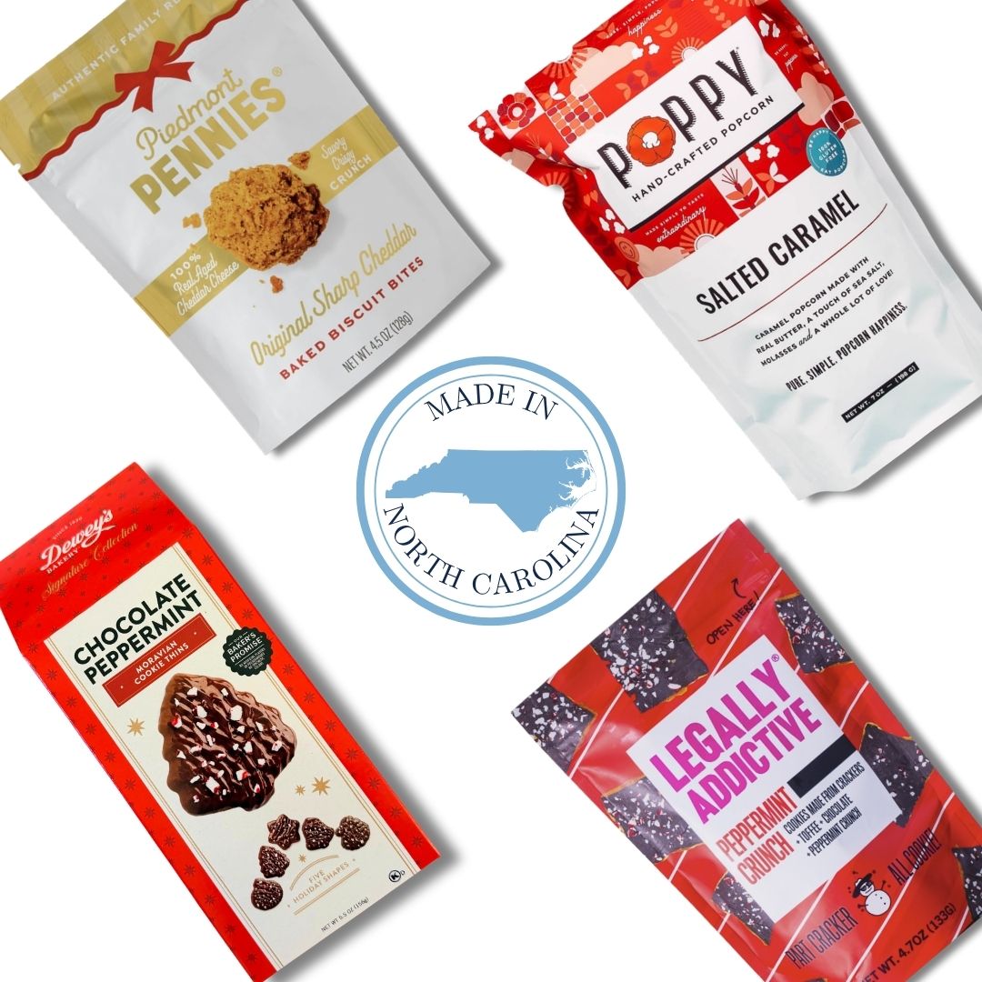 Four packaged gourmet snacks arranged on a white background with a central blue circular 'Made in North Carolina' logo. The packages include Cape Fear Rum Cake (Red Velvet), Poppy Salted Caramel Popcorn