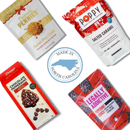 Four packaged gourmet snacks arranged on a white background with a central blue circular 'Made in North Carolina' logo. The packages include Cape Fear Rum Cake (Red Velvet), Poppy Salted Caramel Popcorn