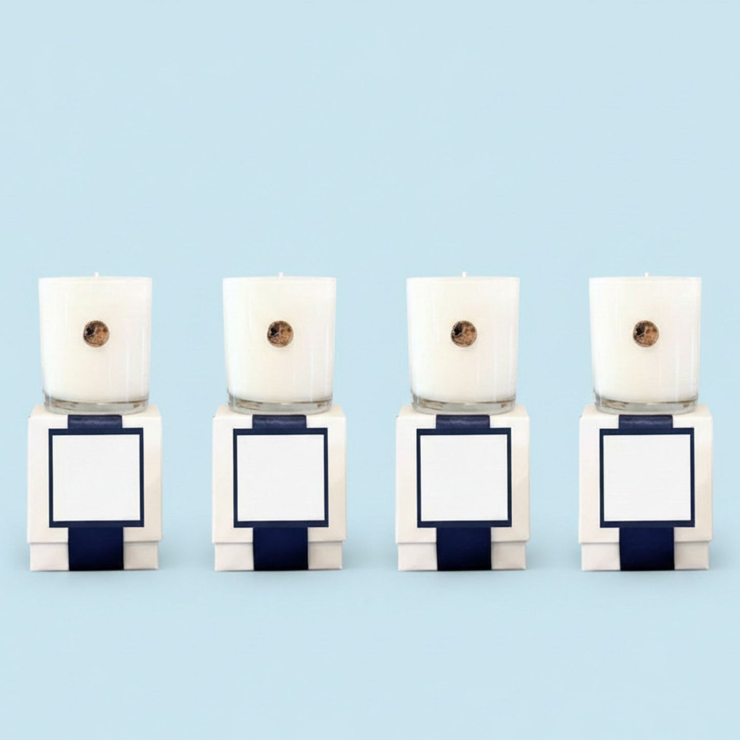 Four white custom branded corporate candles with gold dogwood emblem in luxury gift boxes, North Carolina artisan gifts for businesses