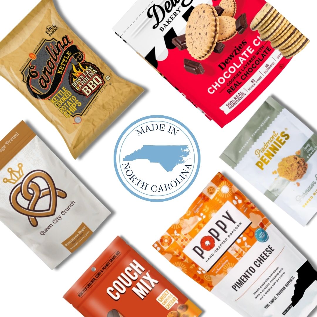 Flat lay image of the Carolina Crafted Gift Basket contents, featuring a variety of sweet and savory North Carolina-made snacks with a Made in NC emblem at the center.