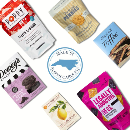 Six packaged snack products arranged around a central circular badge reading 'Made in North Carolina' on a white background. The packages include Poppy Salted Caramel, Cape Fear Rum Cake, Cheez Hutt Toffee, Dewey's Vanilla Bean, Bluffer's Lemon Buds, and Legally Addictive The O.