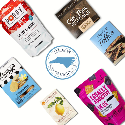 Six packaged snack products arranged around a central circular badge reading 'Made in North Carolina' on a white background. The packages include Poppy Salted Caramel, Cape Fear Rum Cake, Cheez Hutt Toffee, Dewey's Vanilla Bean, Bluffer's Lemon Buds, and Legally Addictive The O.