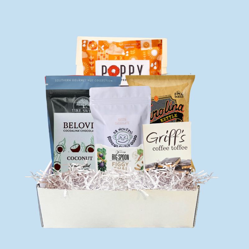 Assorted gluten free North carolina Specialty products in a box with a light blue background
