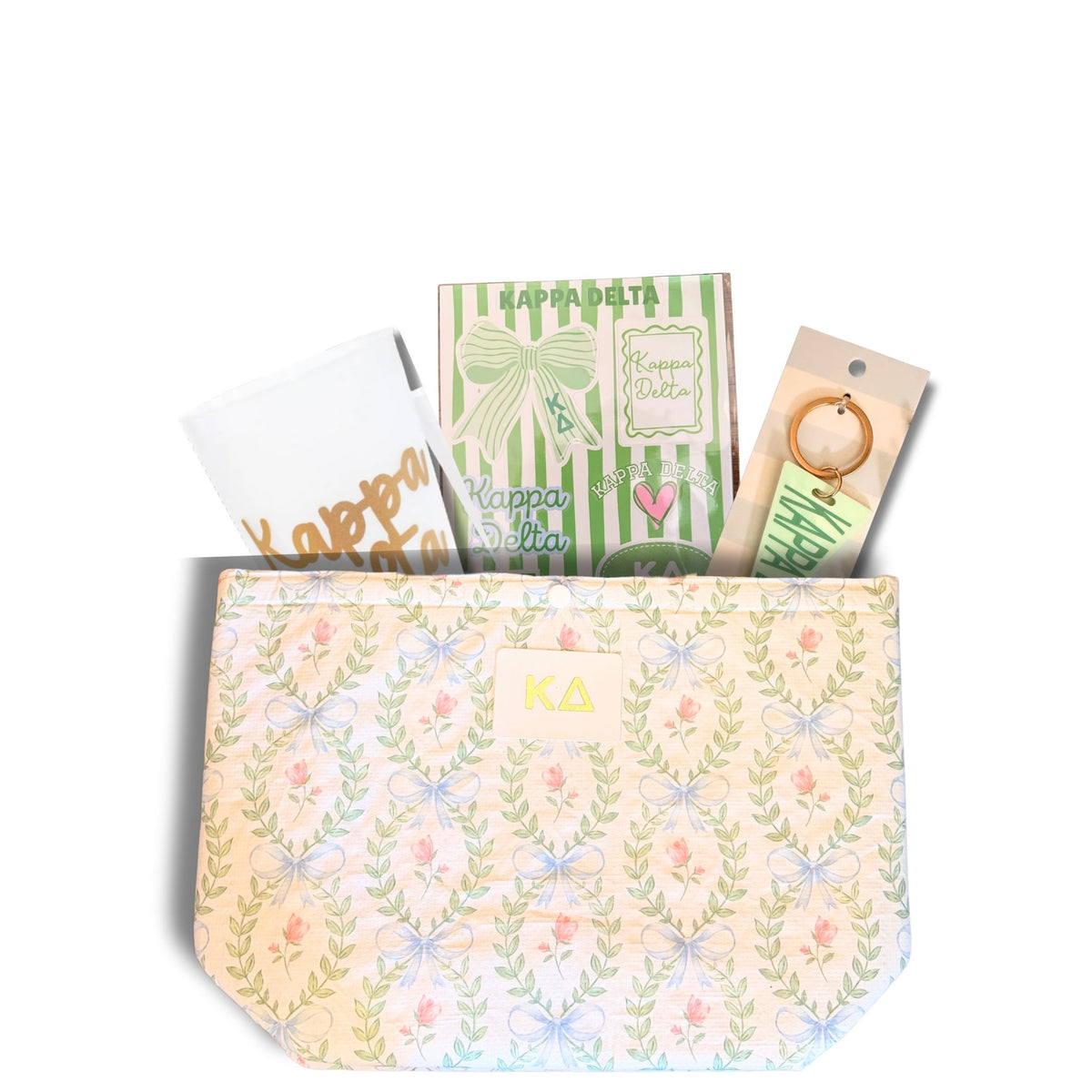 A pastel floral and bow patterned pouch with a small gold 'KD' monogram patch on the front, shown open with gift boxes and wrapped items peeking out against a white background.
