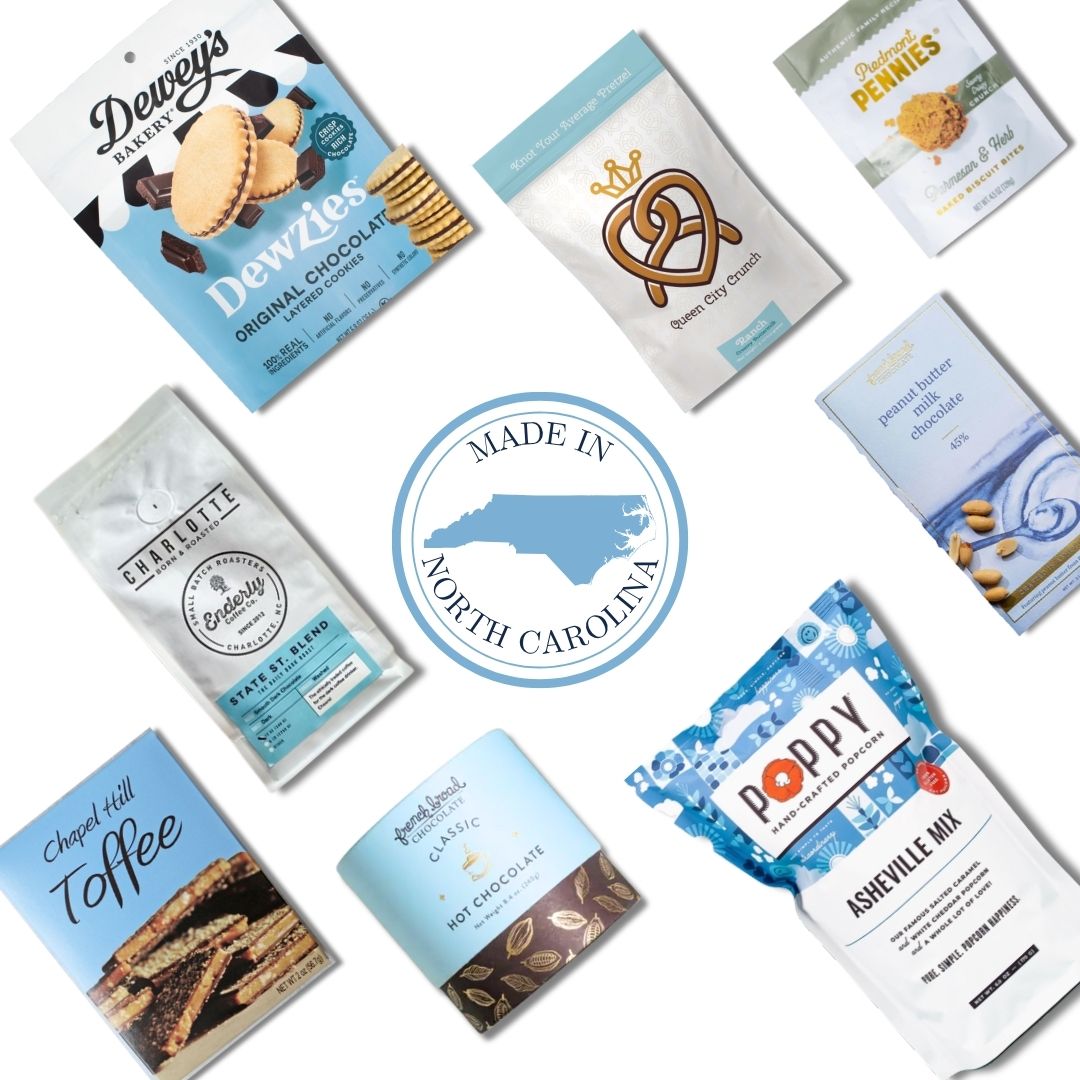 Flay lay of gourmet snacks and treats made in North Carolina, featuring popcorn, pretzels, cookies, toffee, hot chocolate mix, and chocolate from local NC makers, arranged around a central "Made in North Carolina" badge to highlight local, artisanal gift basket ingredients.
