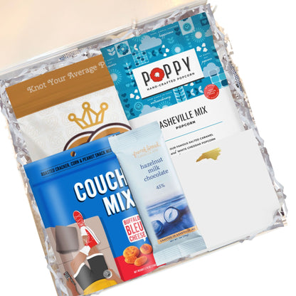 North Carolina corporate welcome box contents with gourmet popcorn, chocolate, and artisan snacks