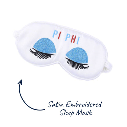 Satin embroidered sleep mask with embroidered eyes and 'PI PHI' text on a white background